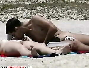 A couple be expeditious for shameless nudists on the shore